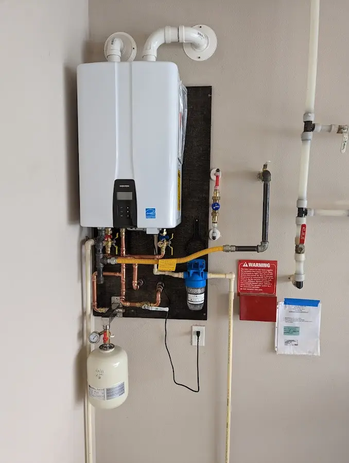 Professional plumber installing copper piping in a Darby home